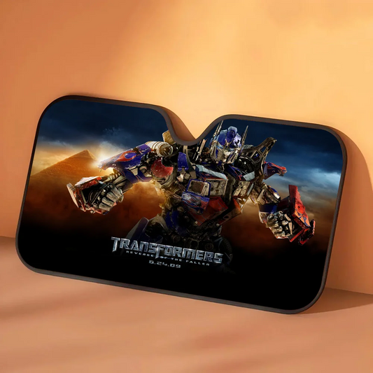 Transformers-zonwering Optimus Prime in zandstorm — autosolbescherming met goudkleurig woestijnthema