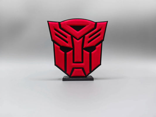 Transformers-plaat met intensrood Autobot-logo — Massieve schilddecoratie voor op het bureau